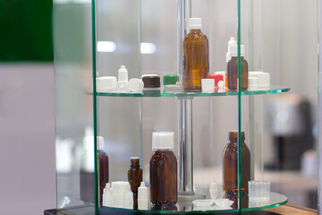 Various bottles for eye drops and medications on a stand