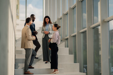 Business people talking on stairs in modern office building