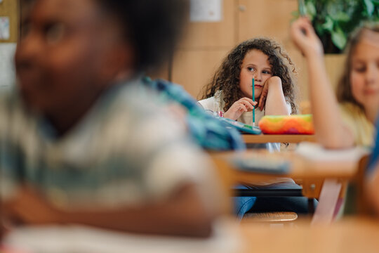 Bored elementary school student daydreaming in class