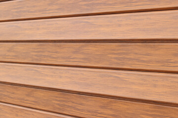 Fototapeta premium Wooden fence, close-up. Texture. Wooden stripes with selective focus. Natural wood texture. Fencing of private territory. Background. Beautiful patterns of wooden boards