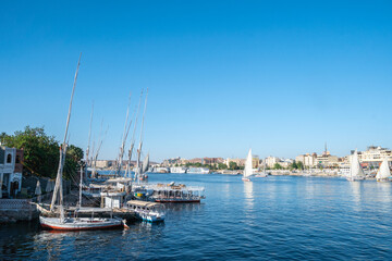 A large sailed sailboat is gracefully floating on the water, Aswan, Egypt