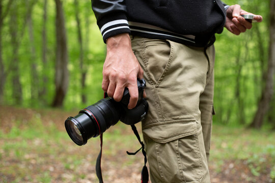 Close up, Yong man asian photographer holding digital camera