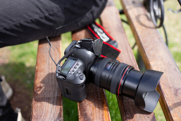 digital camera on the wooden bench