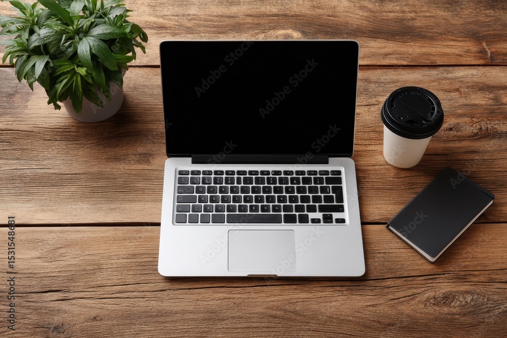 Poster overhead view of a laptop on a wooden desk next to coffee and a notebook, creating a productive and 