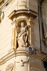 Saint Julian statue in a niche on a street corner in Marsaxlokk