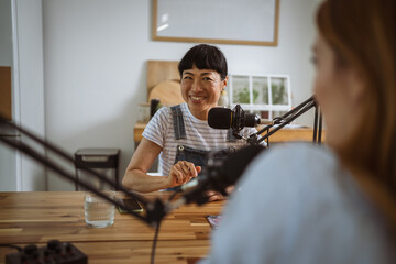 under the shoulder view of japanese host record podcast at home studio