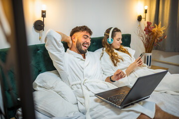 Modern Couple in Bed – Separate Digital Worlds, Shared Space