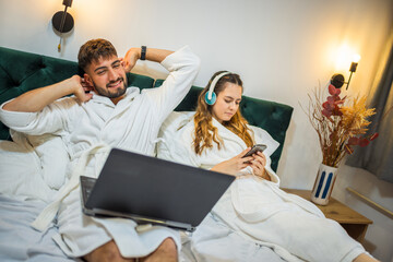 Modern Couple in Bed – Separate Digital Worlds, Shared Space