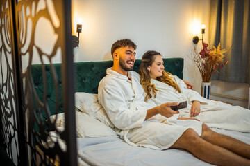 Relaxed Vacation Morning – Couple Watching TV in Bed