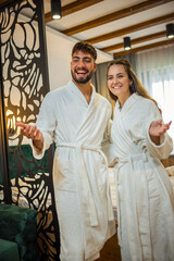 Couple in Bathrobes Admiring Hotel Room Interior