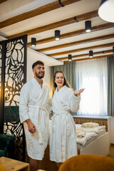 Couple in Bathrobes Admiring Hotel Room Interior