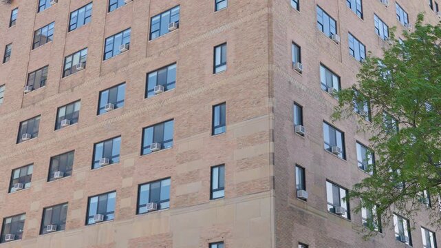 Air conditioners on all windows of apartment complex exterior 4k

