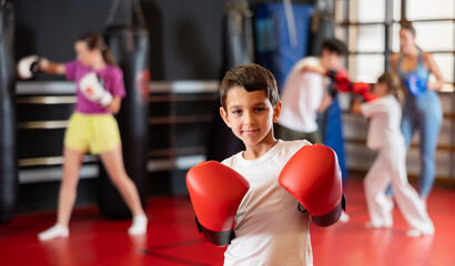 Portrait of a teenage boy in boxing gloves in training. Boxing classes for children