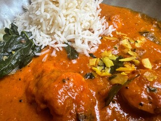 Spicy curry dish with rice and green vegetables