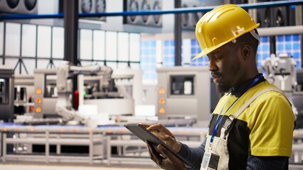 Smart factory specialist testing automated systems, monitoring operational integrity. Industry 4.0...