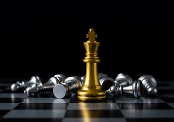 Golden chess king standing tall among fallen silver pieces on chessboard for strategy and leadership