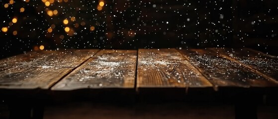 Dark wooden planks table with bokeh lights and snowfall