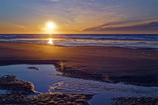 Sunset over a sandy beach at low tide, Juist, Aurich, East Frisia, Lower Saxony, Germany