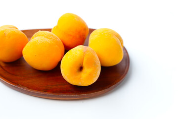 Fresh ripe apricots on a white background.
