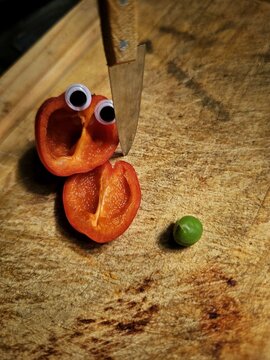 Naklejki Bell peppers playing on the cutting board and green pea