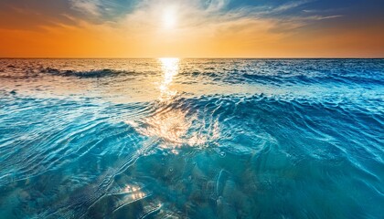 Obraz premium clear water texture in blue and orange background of the ocean and the sea backlit by the sun soft waves natural water