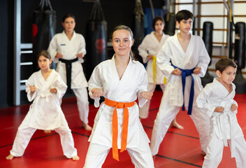 Kata karate teacher conducts classes and performs movements and fighting techniques together with...