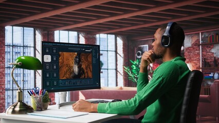 African american guy exploring generative AI art and deep learning visuals on a monitor. Uses predictive technology, virtual assistants and programs to bring prompts to life. Camera B.