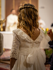 Young Girl in White Dress at First Communion Mass