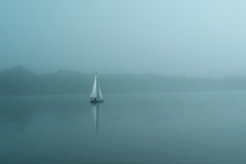 Misty lake scene with sailboat