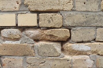 Old brick wall problem and construction industry. Old wall with bricks. Crack and holes in a brick wall. 
