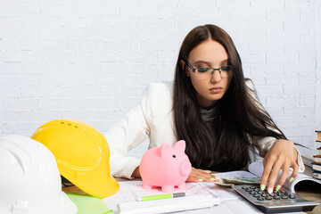 A skilled businesswoman is analyzing her finances while integrating key construction elements