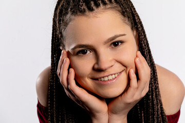 A Cheerful Young Woman with Beautifully Braided Hair Smiling Brightly and Vibrantly