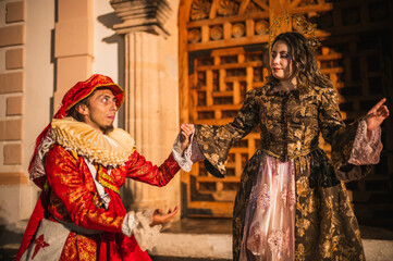 A flirting couple from the Spanish Colonial era, a man in a traditional Spanish red suit with a...