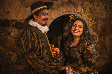 A flirting couple from the Spanish Colonial era, a man in a traditional Spanish suit with a large hat, and a girl with a princess-style tiara in a beautiful dress.