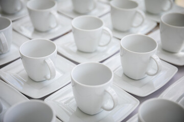 A Set of Elegant White Coffee Cups Tastefully Arranged on Stylish Plates for Presentation