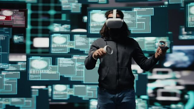 Male spy bypasses network security and engages in cyber intrusion with vr glasses, programming code for data breach and identity theft. Covert cyber operations through infiltration. Camera B.