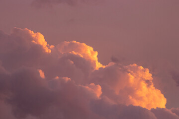 Light in the clouds in the pink sunset