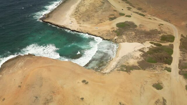 Top-down aerial of Lince&rsquo;s Cove highlighting dramatic rock formations meeting the ocean. Filmed in Aruba on July 2024