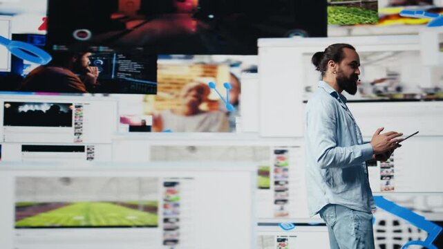 With a hands free microphone, male trend setter hosts a live presentation offering insight for innovation. Speaker discussing with the audience about online entertainment. Camera B.