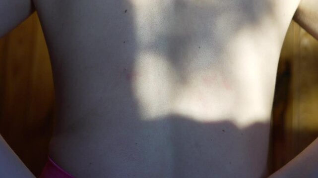 Skin Back Texture close up view of young person's back showing skin texture freckles moles and shadow