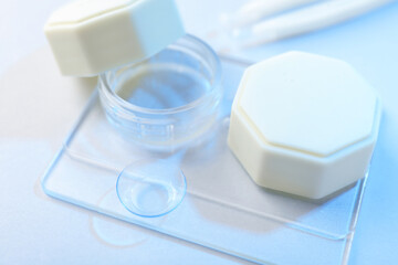 Case with contact lenses on white background, closeup