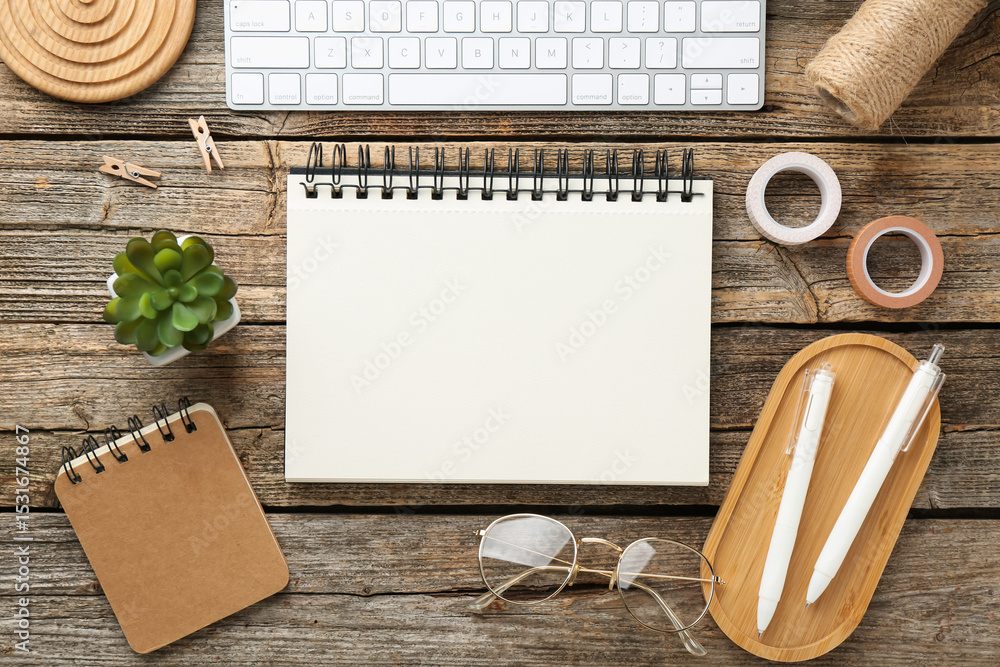 Poster flat lay composition with notebook on wooden table