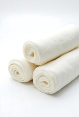 Rolled rice noodles stacked on white background close up studio shot food photo