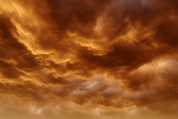 Obraz premium Dramatic orange and brown cloudy sky at sunset