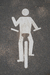 A man is riding a bike on a road