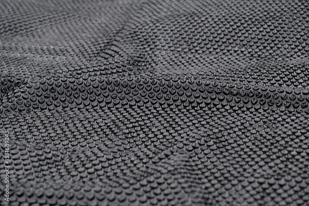 Aufkleber a close up of a black fabric with a pattern of small circles