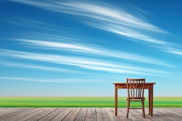 Open Air Workspace on Wooden Patio with Panoramic View of Blue Sky and Green Field