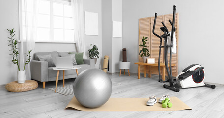 Interior of living room with sports equipment and sofa