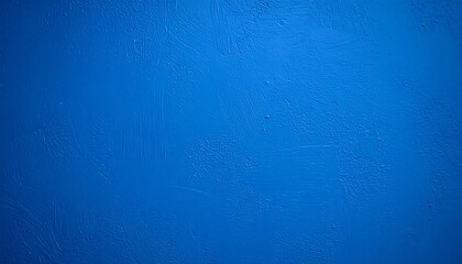 An abstract view of textured blue paint on a wall with visible brush strokes and uneven surface.