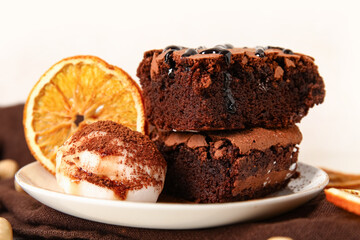 Plate with pieces of tasty chocolate brownie and ice cream on light background